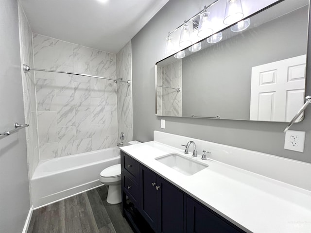 full bathroom with hardwood / wood-style flooring, vanity, toilet, and tiled shower / bath combo