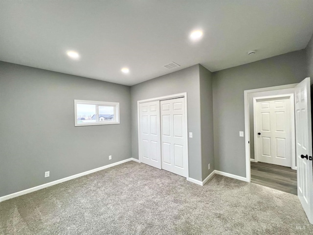 unfurnished bedroom featuring a closet and carpet flooring