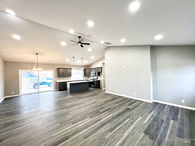 unfurnished living room featuring vaulted ceiling, dark hardwood / wood-style floors, and ceiling fan with notable chandelier