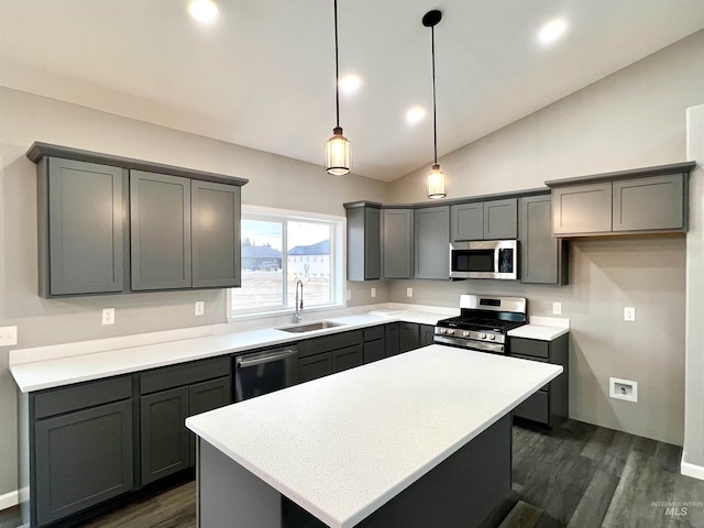 kitchen with gray cabinetry, hanging light fixtures, a center island, and appliances with stainless steel finishes