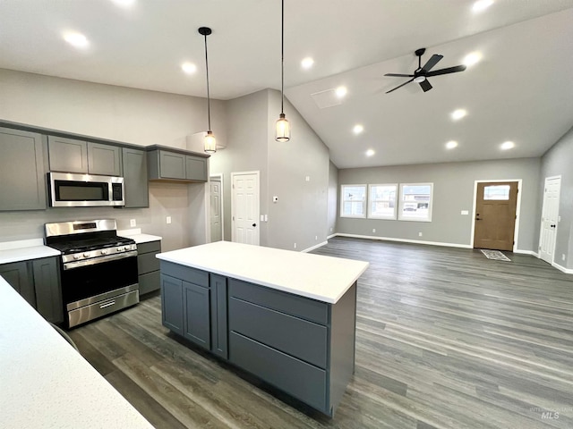 kitchen featuring a center island, high vaulted ceiling, appliances with stainless steel finishes, gray cabinets, and pendant lighting