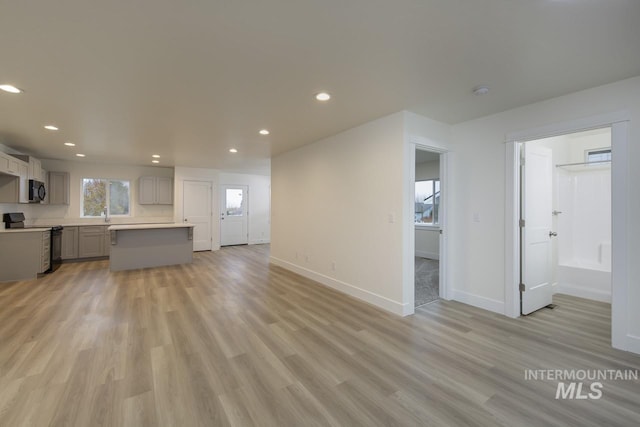 1611 Regency Way, Emmett, ID 83617 - unfurnished living room with recessed lighting and light wood-type flooring