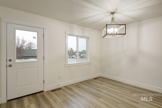 1611 Regency Way, Emmett, ID 83617 - unfurnished dining area featuring a chandelier and light wood-type flooring