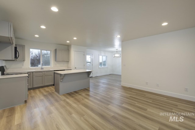 1611 Regency Way, Emmett, ID 83617 - kitchen featuring gray cabinetry, a kitchen island, recessed lighting, light countertops, and light wood-style floors