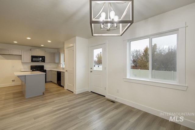 1611 Regency Way, Emmett, ID 83617 - kitchen featuring black appliances, light wood finished floors, a chandelier, recessed lighting, and light countertops