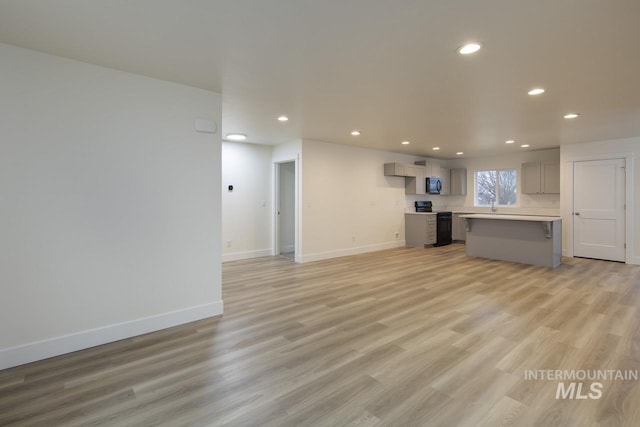 1611 Regency Way, Emmett, ID 83617 - unfurnished living room with recessed lighting and light wood-style floors