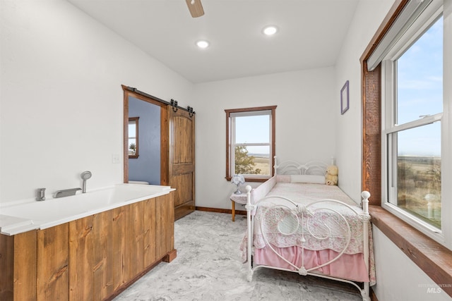 340 Gill Point Rd, Grangeville, ID 83530 - bedroom with multiple windows, ceiling fan, and a barn door