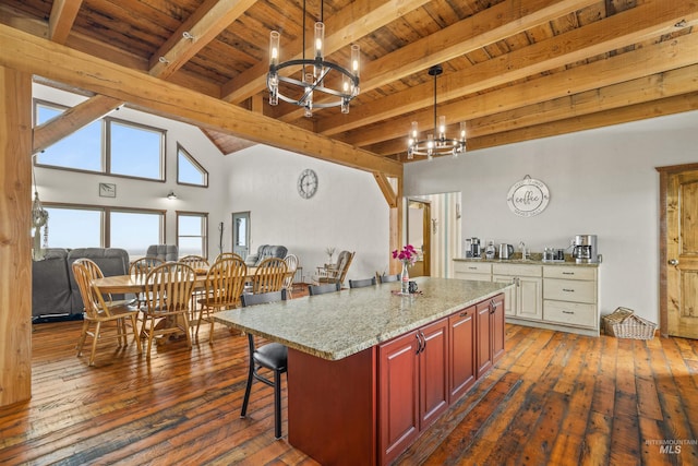 340 Gill Point Rd, Grangeville, ID 83530 - kitchen with a center island, dark wood-type flooring, hanging light fixtures, beam ceiling, and a breakfast bar area