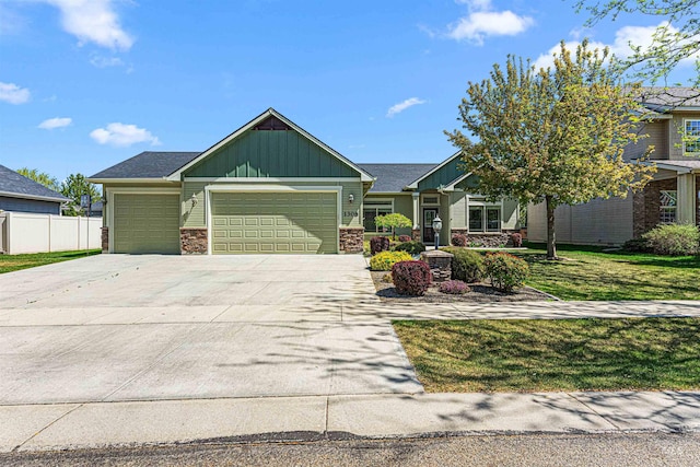 craftsman inspired home featuring board and batten siding, concrete driveway, stone siding, and a garage