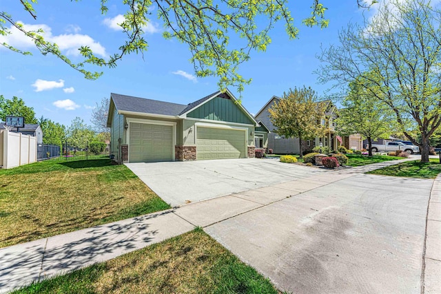 view of front of property with fence, a front lawn, board and batten siding, an attached garage, and driveway