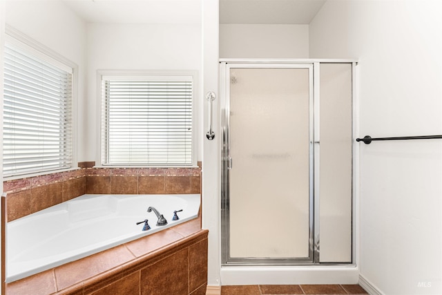 full bath featuring a shower stall and a garden tub