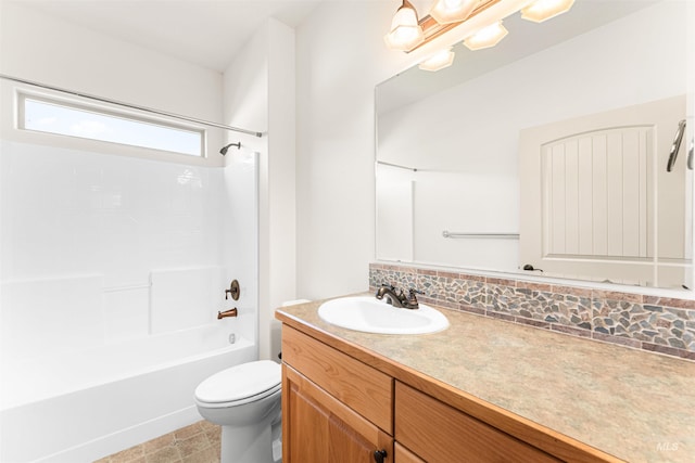 full bathroom featuring washtub / shower combination, tasteful backsplash, toilet, and vanity