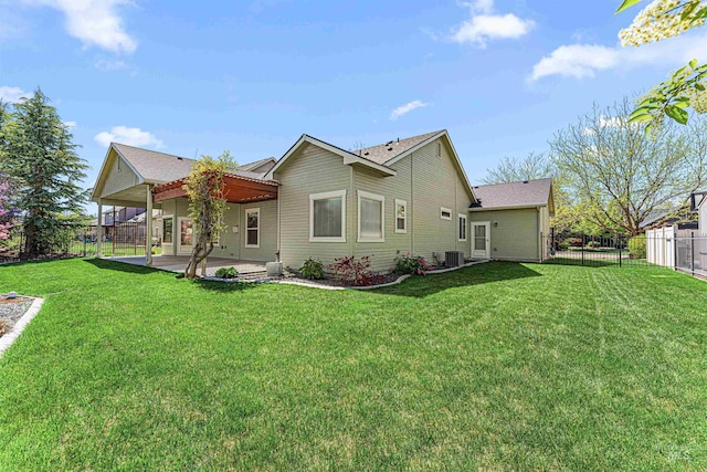 rear view of property featuring a lawn, central AC, a patio, and a fenced backyard
