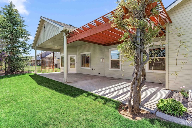 rear view of property with a pergola, a yard, a patio area, and fence