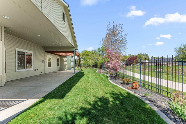 view of yard with fence and a patio