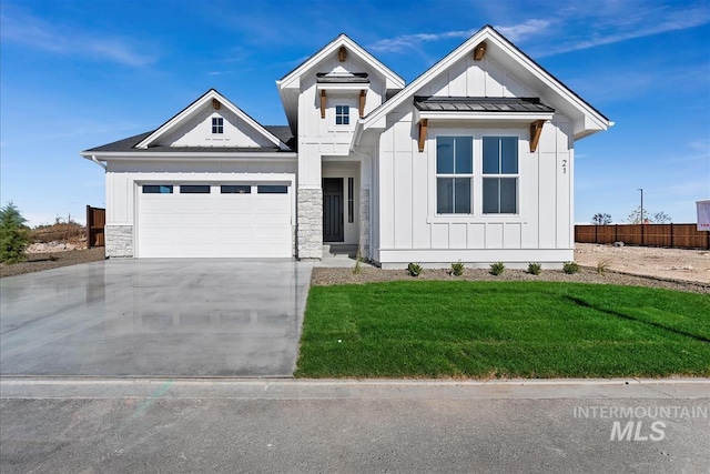 view of front of property with a garage and a front yard