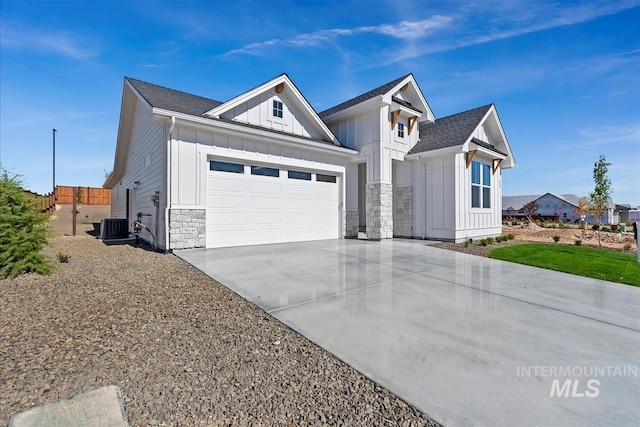 view of front of house featuring cooling unit and a garage