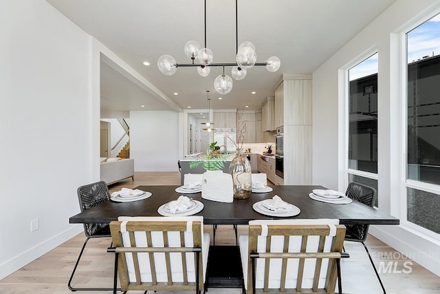 2528 S Linnet Pl, Boise, ID 83716 - dining space with stairs, light wood-style flooring, a chandelier, baseboards, and recessed lighting
