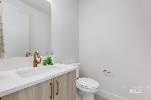 2528 S Linnet Pl, Boise, ID 83716 - half bath featuring toilet, vanity, tile patterned floors, and baseboards