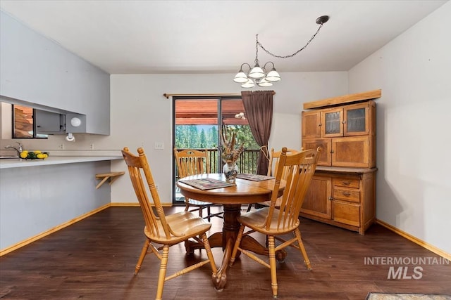 dining room featuring a notable chandelier and dark hardwood / wood-style floors