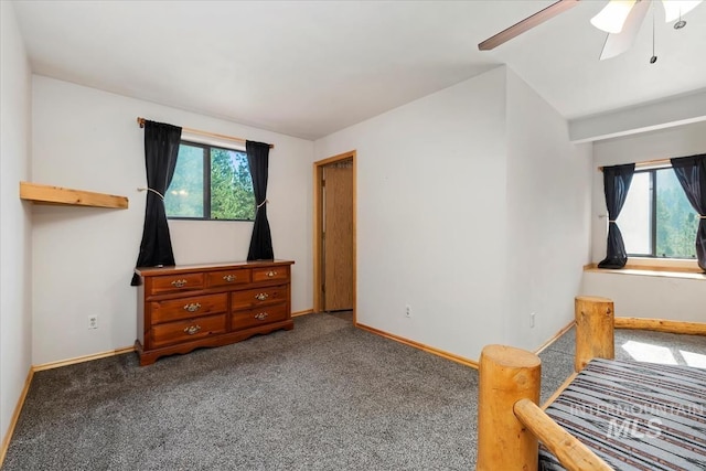 bedroom with carpet floors, ceiling fan, vaulted ceiling, and baseboards