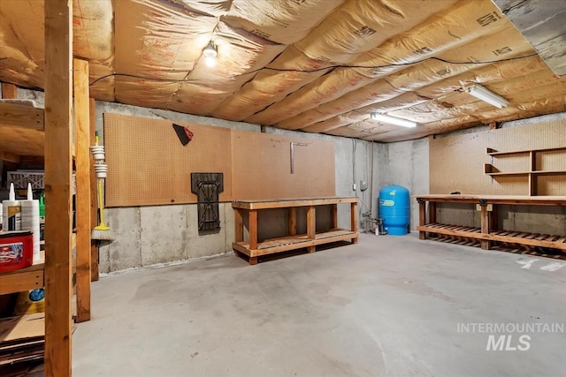 unfinished basement featuring a workshop area