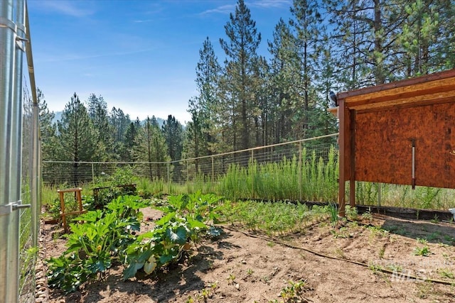 view of yard with fence and a view of trees