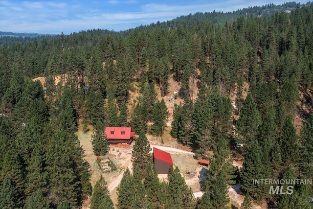 birds eye view of property featuring a forest view
