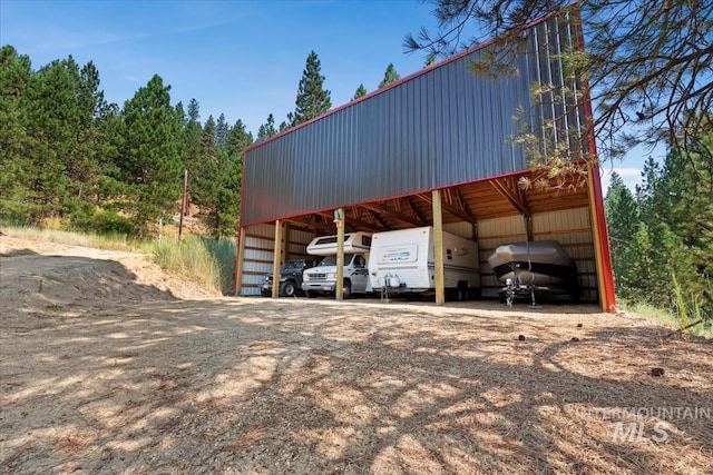 view of parking with heating fuel and a detached carport