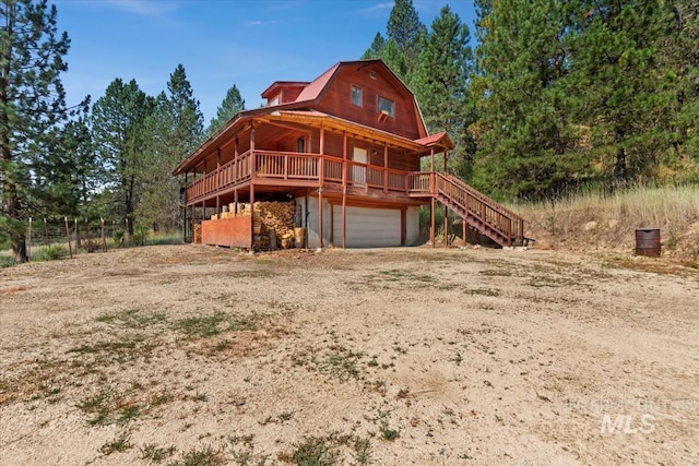 log home featuring a garage and a deck