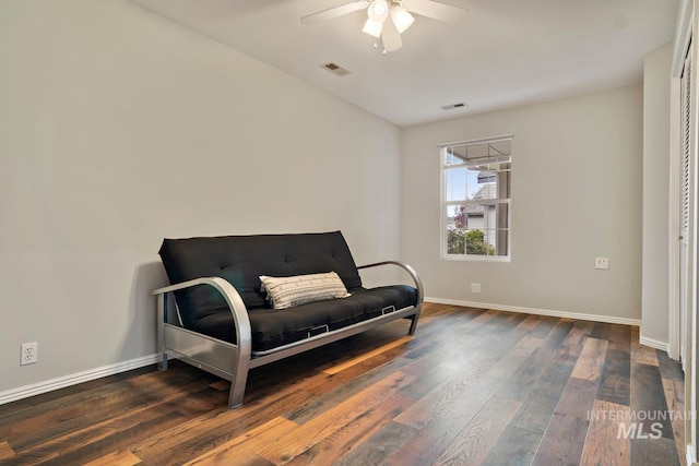 sitting room featuring visible vents, wood finished floors, baseboards, and ceiling fan