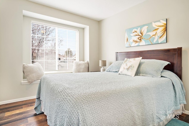 bedroom featuring baseboards and wood finished floors