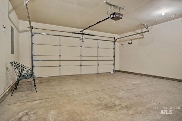 garage featuring electric panel, baseboards, and a garage door opener