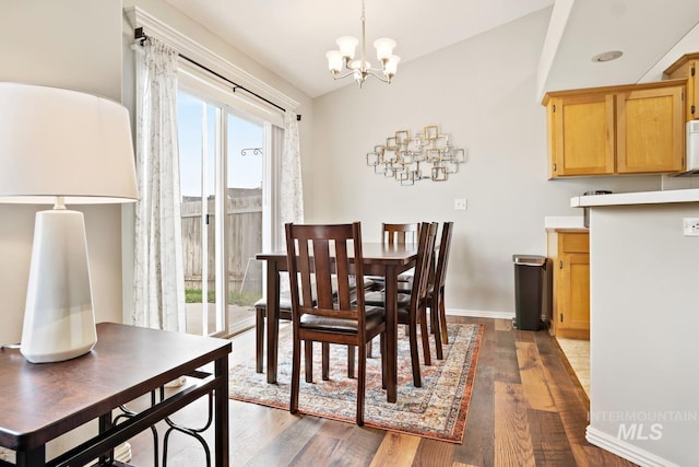 dining room featuring baseboards, a notable chandelier, and dark wood finished floors