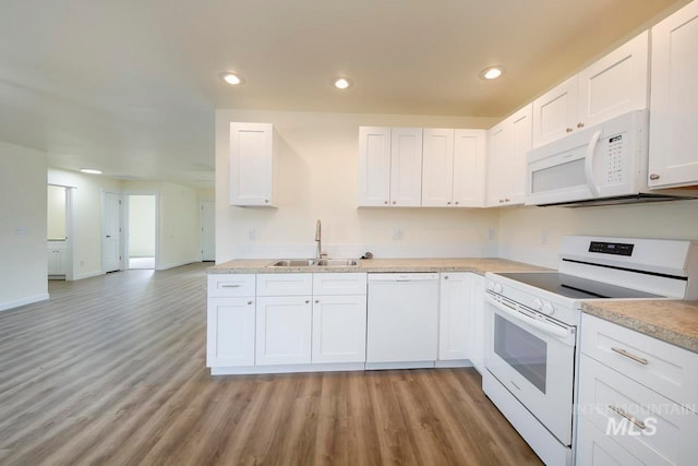 kitchen featuring sink, white cabinetry, light wood-type flooring, and white appliances