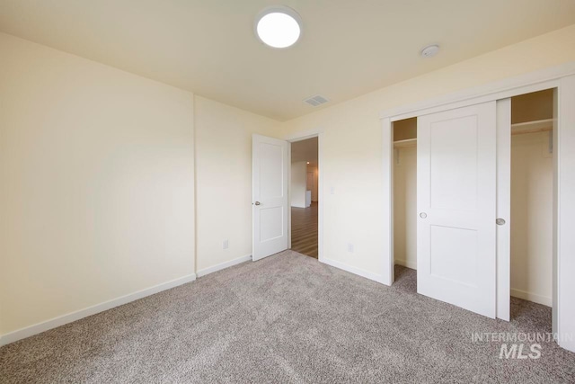 unfurnished bedroom featuring carpet floors and a closet