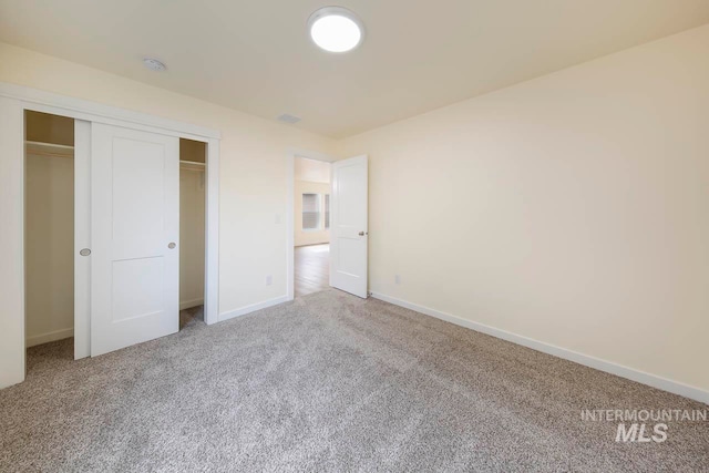 unfurnished bedroom with a closet and carpet flooring