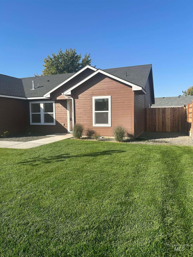 back of house with a lawn