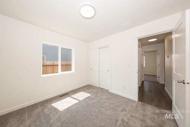 unfurnished bedroom featuring a closet and carpet