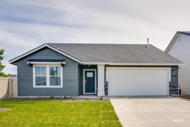 ranch-style house featuring a garage and a front lawn