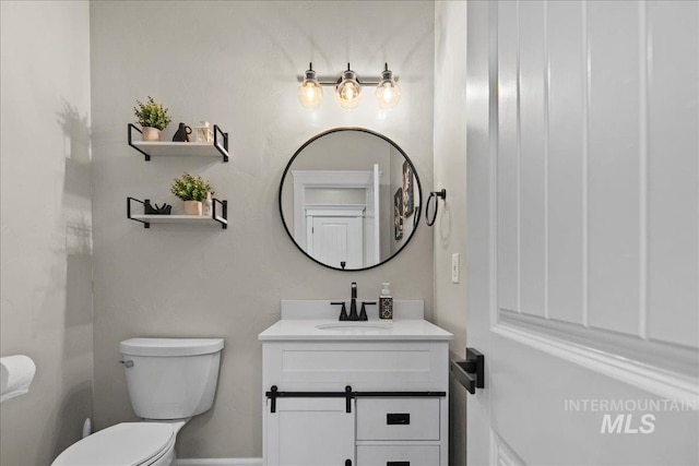 bathroom with toilet and vanity