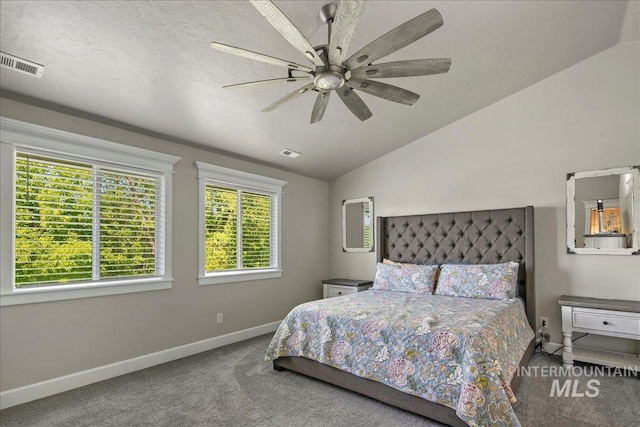 carpeted bedroom featuring baseboards, lofted ceiling, and ceiling fan