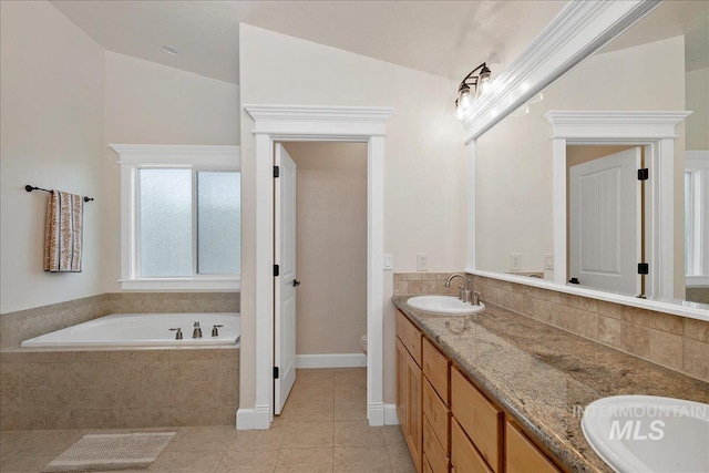 full bath with tile patterned flooring, vaulted ceiling, toilet, a bath, and double vanity