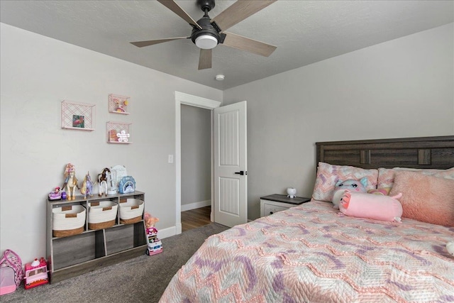 carpeted bedroom featuring baseboards and ceiling fan