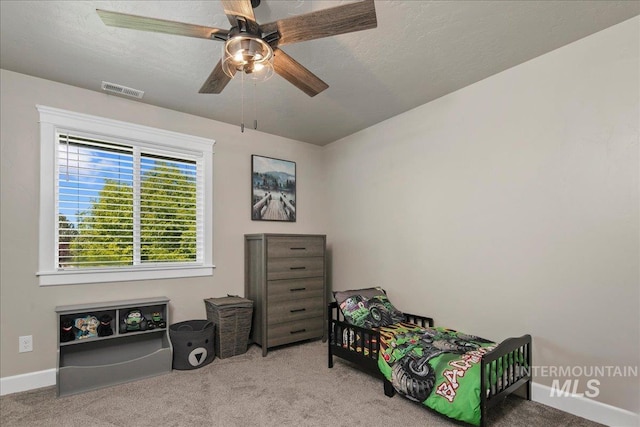 carpeted bedroom with baseboards and ceiling fan