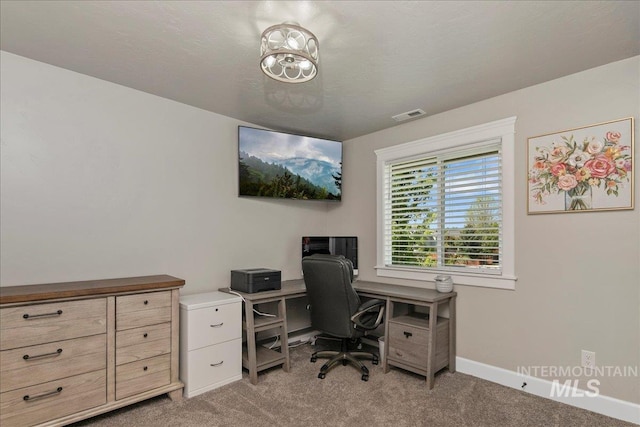 office with light colored carpet and baseboards