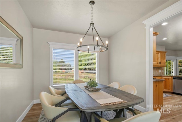 dining space with a chandelier, light wood-style floors, baseboards, and recessed lighting