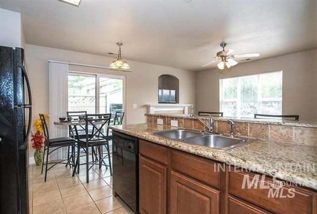 kitchen with ceiling fan, sink, pendant lighting, light tile patterned flooring, and black appliances