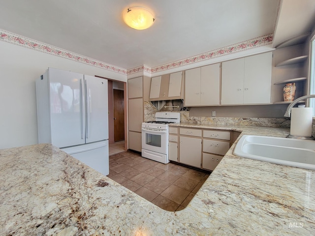 kitchen featuring light tile patterned flooring, white appliances, a sink, light countertops, and open shelves