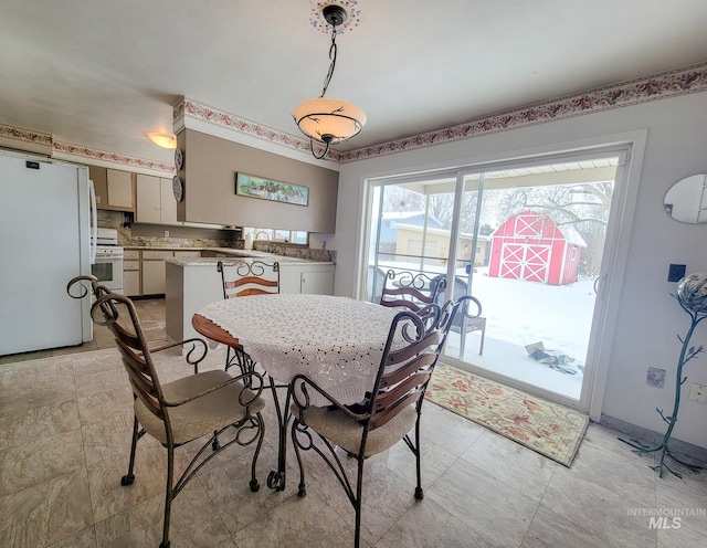 dining room featuring baseboards